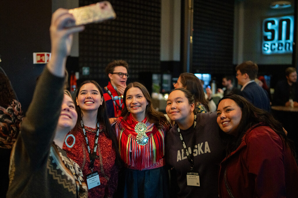 A group of youth from several Arctic countries taking a selfie together.
